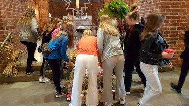 Konfirmander ligger høstgaver i kirken